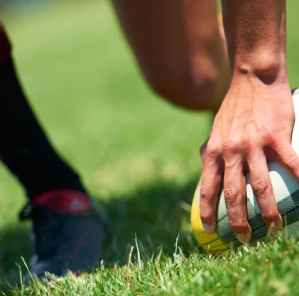 Detailed sports photograph highlighting preparation and focus before a rugby play.