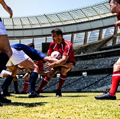 Dynamic rugby action showing teamwork, strength, and strategy in a stadium environment.